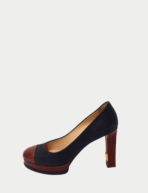 Chanel navy leather pumps with wooden cap toe, matching wooden block heel, and gold-tone logo detail on the heel