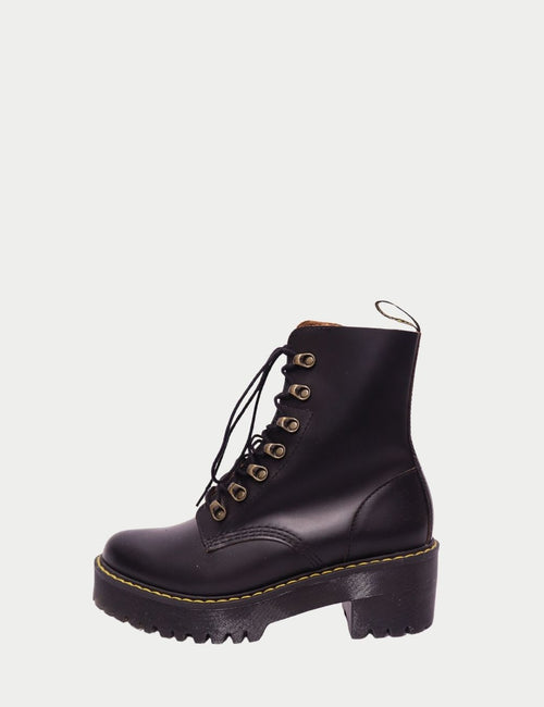 Dr. Martens black leather platform combat boots with yellow stitching and lace-up design