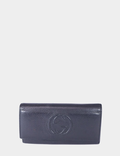Gucci black pebbled leather wallet with embossed interlocking GG logo and flap closure