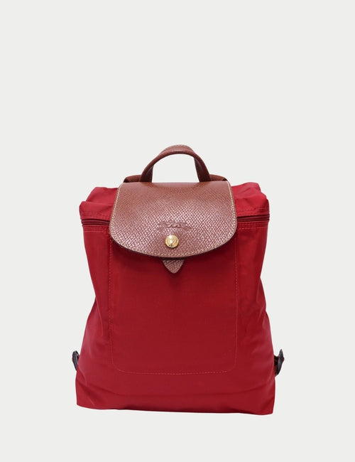 Longchamp Le Pliage red nylon backpack with brown leather flap and gold snap button
