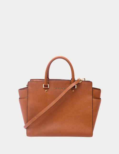 Michael Kors camel brown leather tote bag with top handles, detachable crossbody strap, and gold-tone hardware