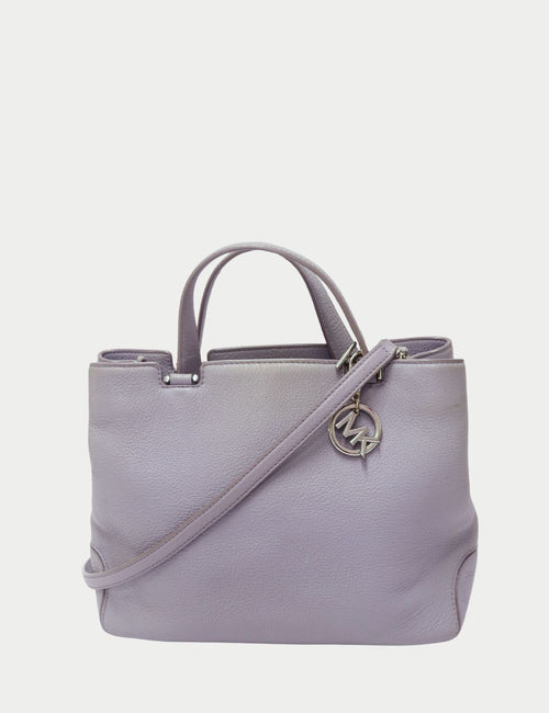 Michael Kors light grey pebbled leather tote bag with top handles, detachable crossbody strap, and silver MK logo charm.