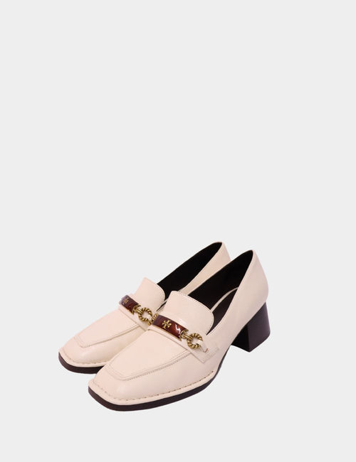 Tory Burch cream leather loafers with gold chain and logo detail across the front