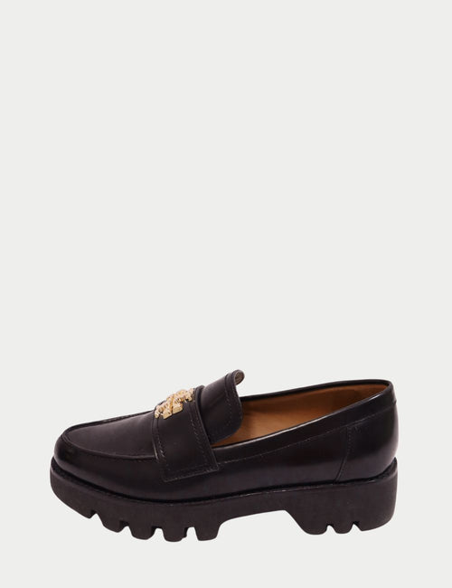"Tory Burch black leather chunky loafers with gold logo and lug sole"