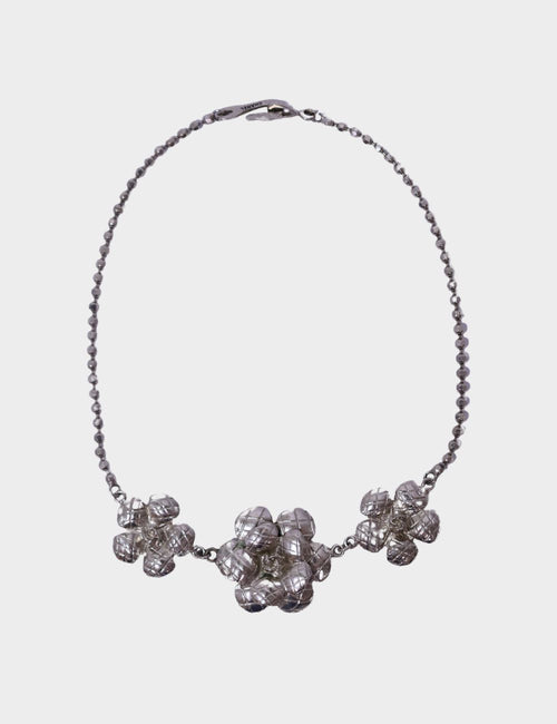Chanel silver-tone statement necklace with three-dimensional textured floral motifs and beaded chain.