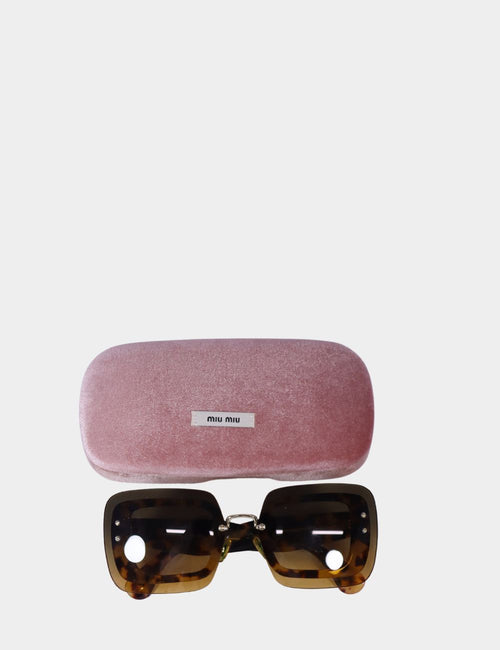 Miu Miu oversized tortoiseshell shield sunglasses with brown gradient lenses and gold logo on arms