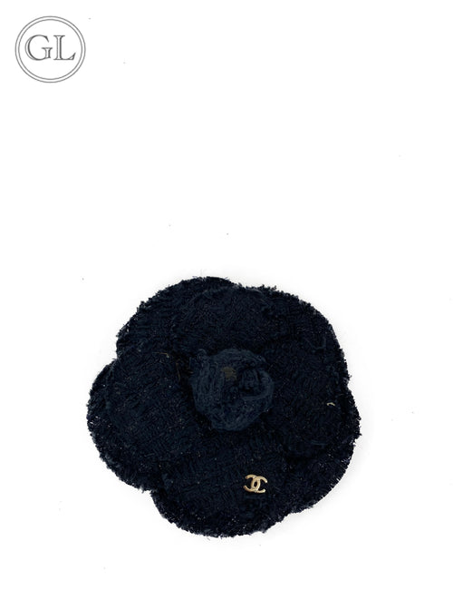 "Chanel black tweed Camellia brooch with gold CC logo"