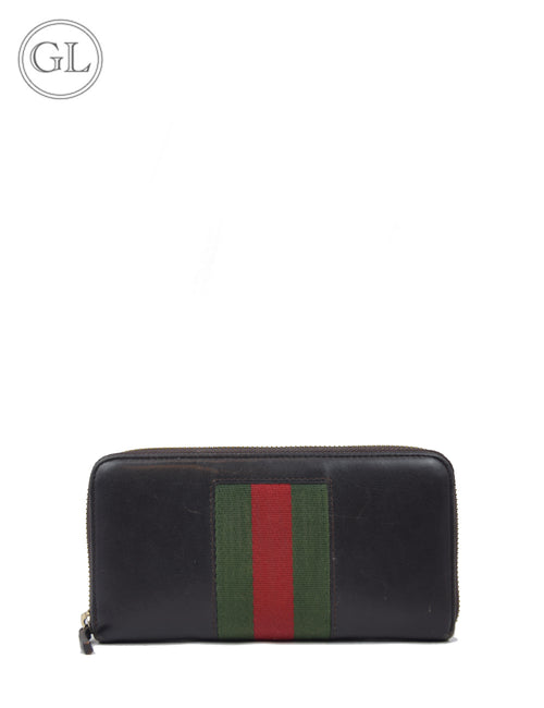 Gucci black leather zip-around wallet with green and red Web stripe.