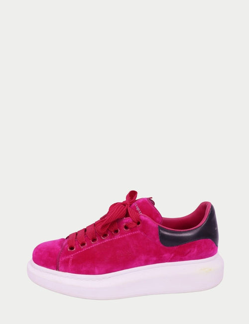 Alexander McQueen pink suede platform sneakers with black leather heel tab and white oversized rubber sole.