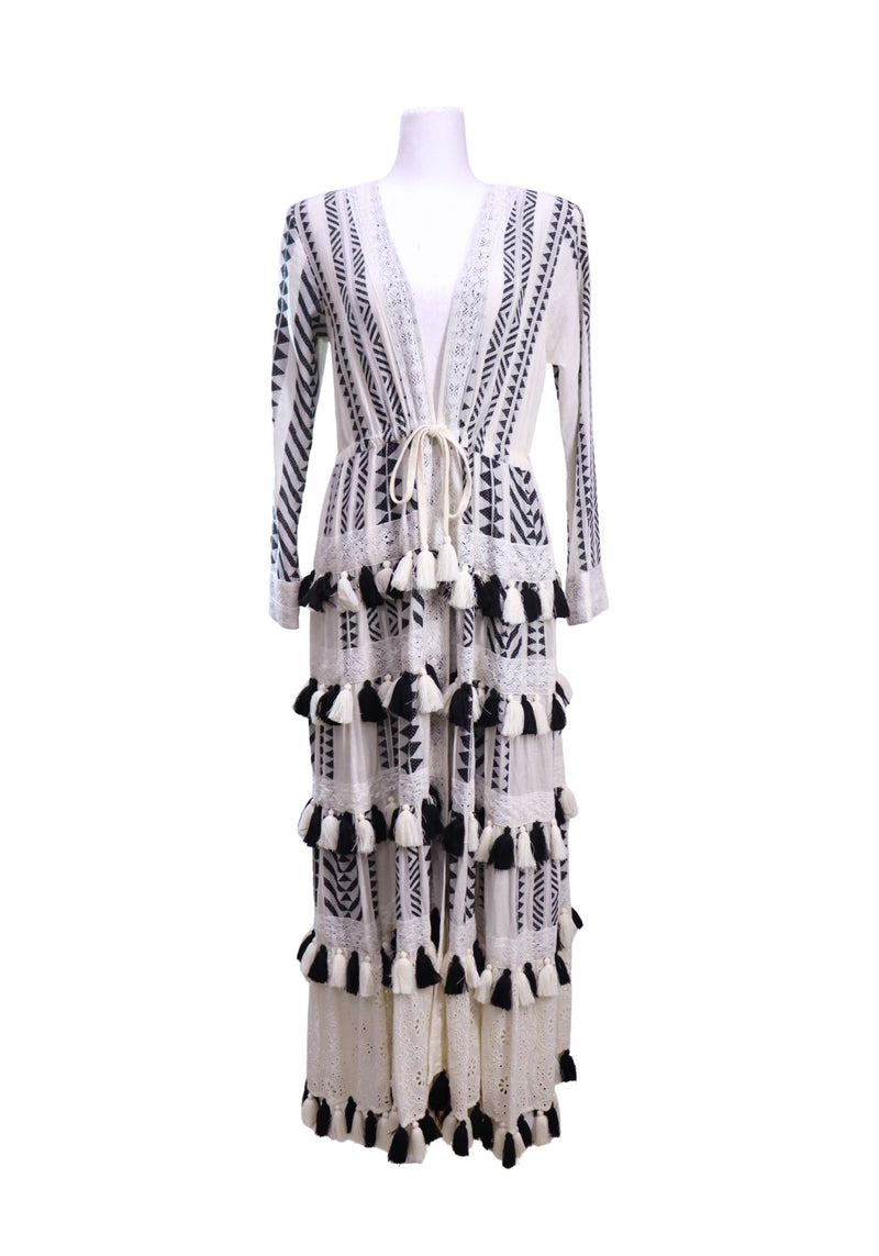Alice + Olivia black and white bohemian maxi cardigan featuring geometric patterns, lace trim details, tassel embellishments, long sleeves, and an adjustable waist tie