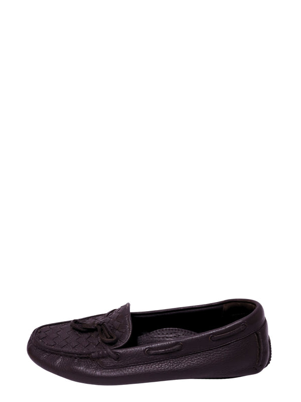 Authentic Bottega Veneta black leather driving loafers featuring the signature Intrecciato woven vamp, leather tassels, and slip-on moccasin silhouette