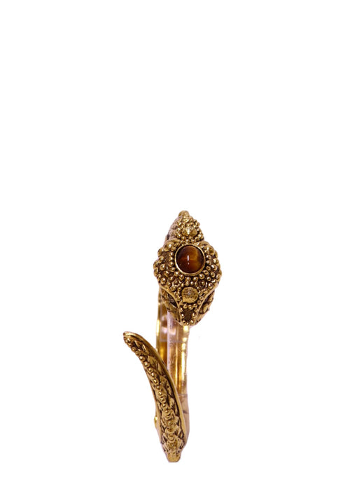 Roberto Cavalli antique gold-tone serpent cuff bracelet featuring a sculpted snake head with a round polished brown cabochon-style stone, intricate raised beading, ornate engraved detailing and a curved serpent tail