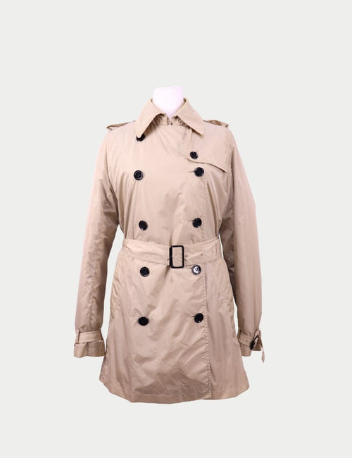 Beige double-breasted belted trench rain coat by Burberry featuring classic collar and black button detailing