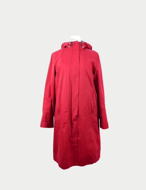 Red hooded rain coat by Burberry featuring concealed front closure, zip pockets, and straight-cut silhouette
