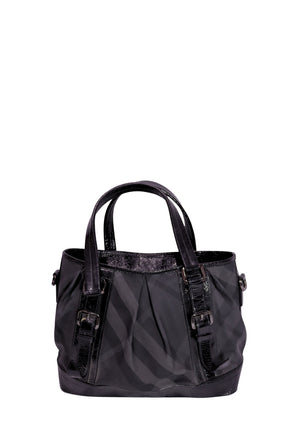 Burberry black Nova Check nylon tote bag with patent leather trim, buckle details, and dual top handles.
