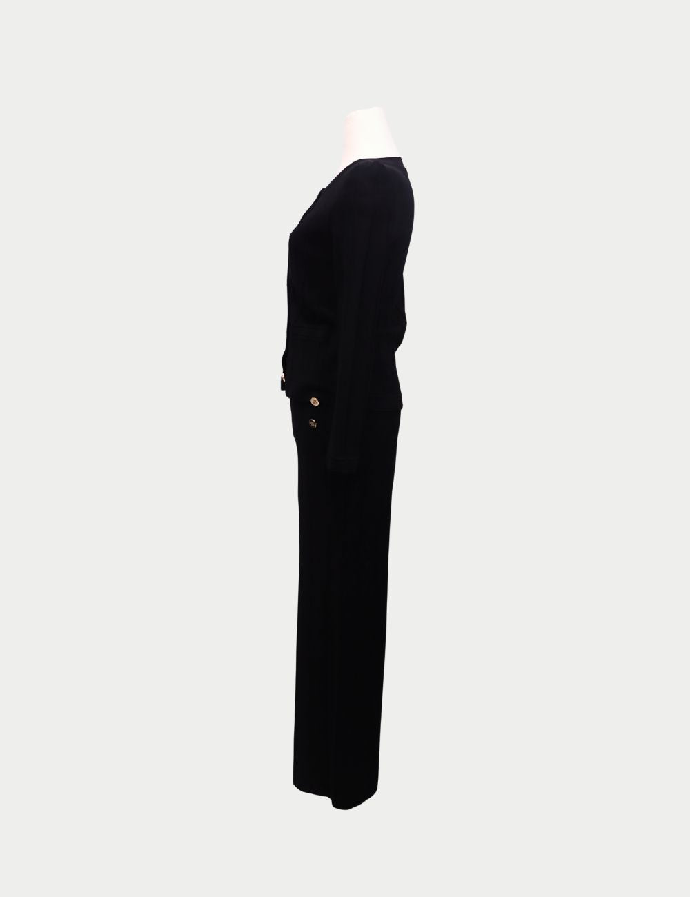 Sophisticated and timeless, this Carolina Herrera two-piece set is crafted in black knit fabric for an effortlessly polished look. The set includes a fitted cardigan-style top with round neckline, long sleeves, front pockets, and gold button detailing, pa Sophisticated and timeless, this Carolina Herrera two-piece set is crafted in black knit fabric for an effortlessly polished look. The set includes a fitted cardigan-style top with round neckline, long sleeves, front pockets, and gold button detailing, pa