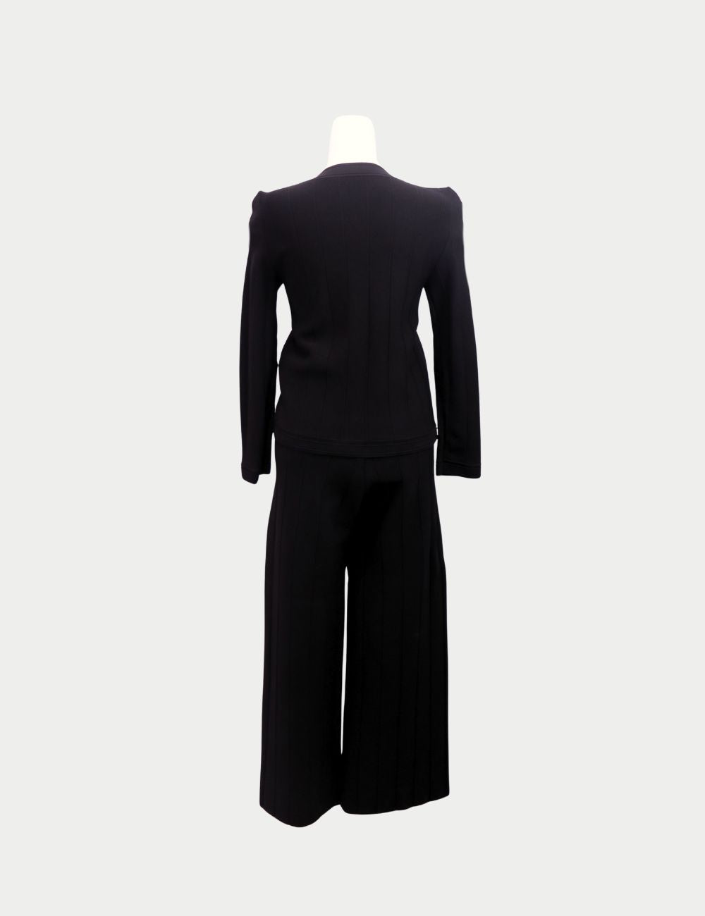 Sophisticated and timeless, this Carolina Herrera two-piece set is crafted in black knit fabric for an effortlessly polished look. The set includes a fitted cardigan-style top with round neckline, long sleeves, front pockets, and gold button detailing, pa Sophisticated and timeless, this Carolina Herrera two-piece set is crafted in black knit fabric for an effortlessly polished look. The set includes a fitted cardigan-style top with round neckline, long sleeves, front pockets, and gold button detailing, pa