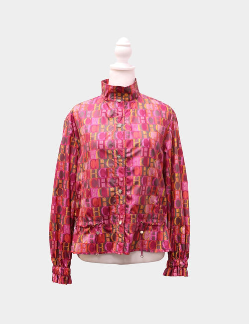 Carolina Herrera lightweight jacket in vibrant pink and orange CH logo print, with rushed cuffs and drawstring hem.