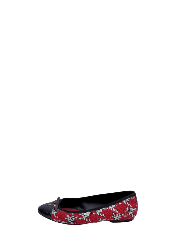 Carolina Herrera ballet flats featuring a red tweed upper, black cap toe, and delicate bow detail