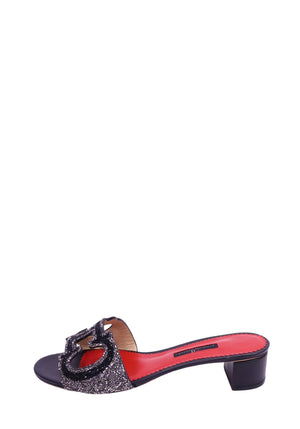Carolina Herrera black leather slide sandals with crystal CH logo embellishment, block heel, and red leather footbed