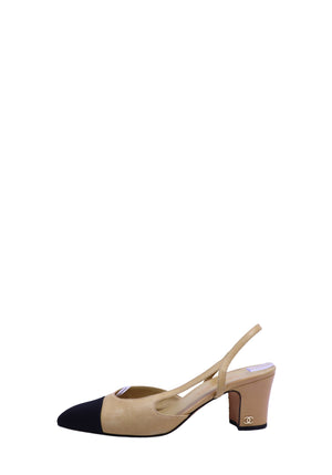 Chanel beige and black slingback pumps featuring a signature black cap toe, block heel, and gold CC logo detail