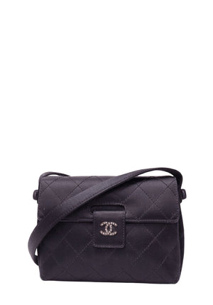 Chanel black quilted fabric flap crossbody bag with crystal-embellished silver-tone CC logo, matching black shoulder strap and diamond stitching