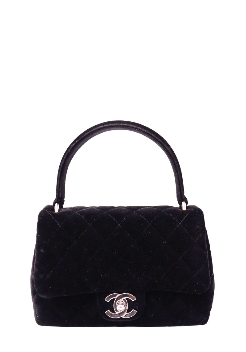 Chanel black diamond-quilted velvet top handle flap bag with silver-tone CC turn-lock closure