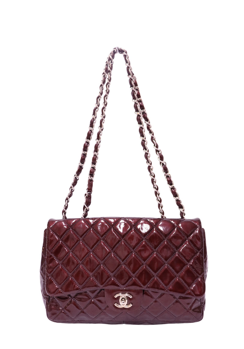 Chanel burgundy patent leather quilted flap shoulder bag featuring glossy diamond quilting, silver-tone interlocking CC turn-lock closure and double burgundy leather-interwoven chain straps