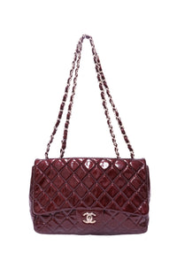 Chanel burgundy patent leather quilted flap shoulder bag featuring glossy diamond quilting, silver-tone interlocking CC turn-lock closure and double burgundy leather-interwoven chain straps