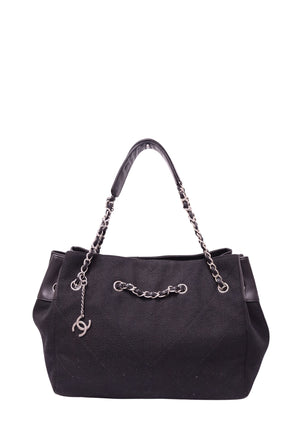 Chanel black woven tote bag with leather trim, silver-tone chain handles and CC charm