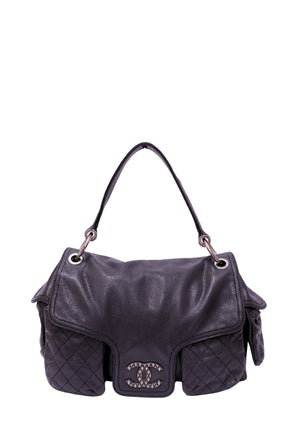 Chanel Coco Rider Multi-Pocket Flap Bag in black caviar leather featuring a single rolled top handle, silver-tone CC hardware, and quilted exterior flap pockets.