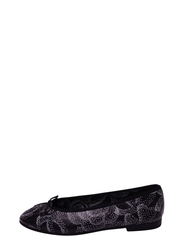 Chanel black leather ballet flat featuring an intricate white dotted abstract pattern, delicate black bow, rounded toe, black trim, and low heel