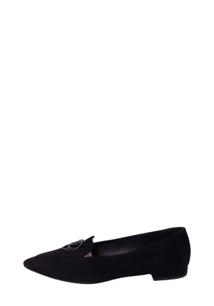 Chanel black suede pointed-toe loafer featuring a decorative suede front strap, glossy black interlocking CC logo embellishment, sleek low-cut silhouette, and low stacked heel