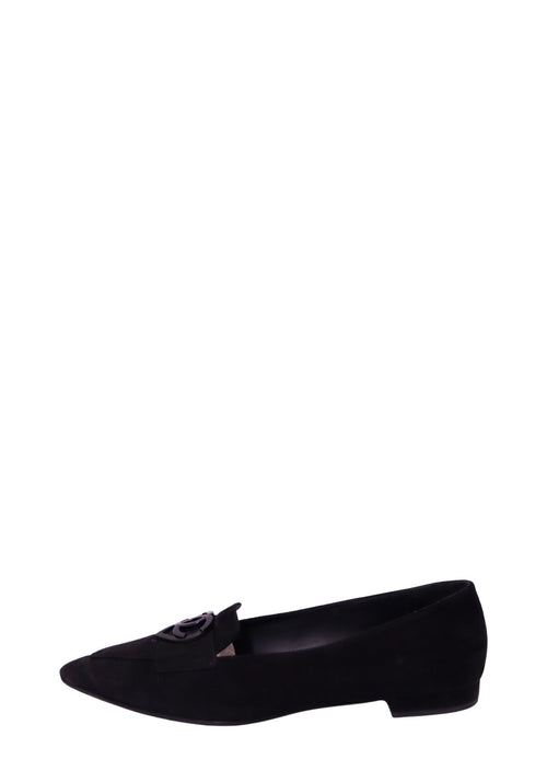 Chanel black suede pointed-toe loafer featuring a decorative suede front strap, glossy black interlocking CC logo embellishment, sleek low-cut silhouette, and low stacked heel