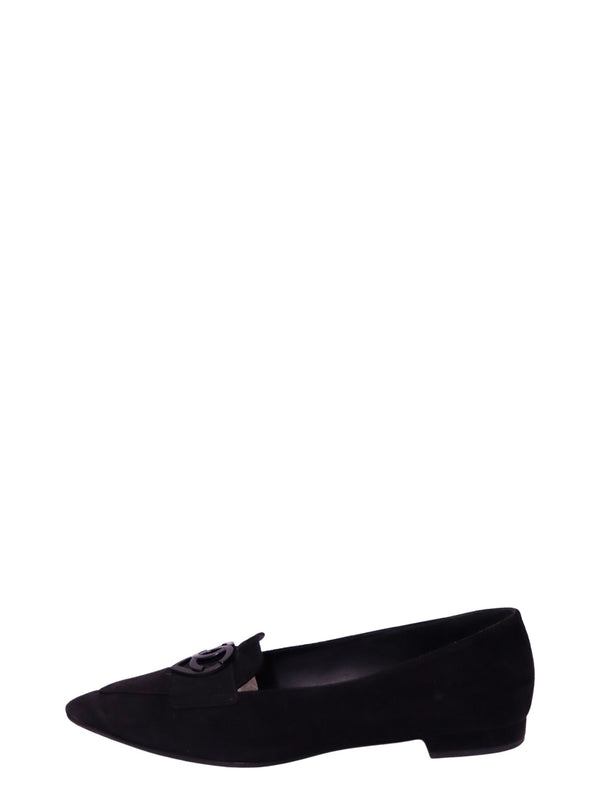 Chanel black suede pointed-toe loafer featuring a decorative suede front strap, glossy black interlocking CC logo embellishment, sleek low-cut silhouette, and low stacked heel