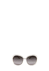 Chloé oversized sunglasses with a gold-tone metal frame, rounded geometric shape, slim temples, and grey gradient lenses.