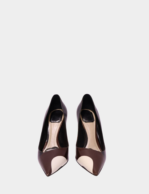 Christian Dior pointed-toe heels in brown and cream patent leather with bold color block design, displayed front-facing on a plain background