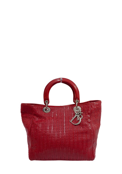 Christian Dior Lady Dior red woven leather tote bag with structured top handles and signature silver-tone D.I.O.R. letter charms.