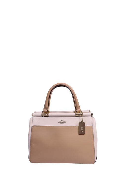 Coach colorblock leather carryall tote handbag in beige and blush pink with gold-tone hardware, dual top handles, and Coach leather hangtag.