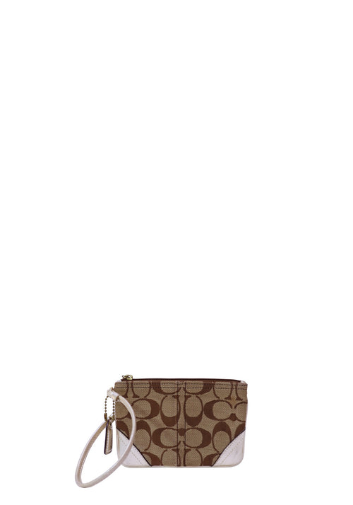 Coach mini wristlet in signature khaki and brown canvas featuring the iconic Coach monogram pattern, white leather corner accents, zip-top closure, and detachable wrist strap