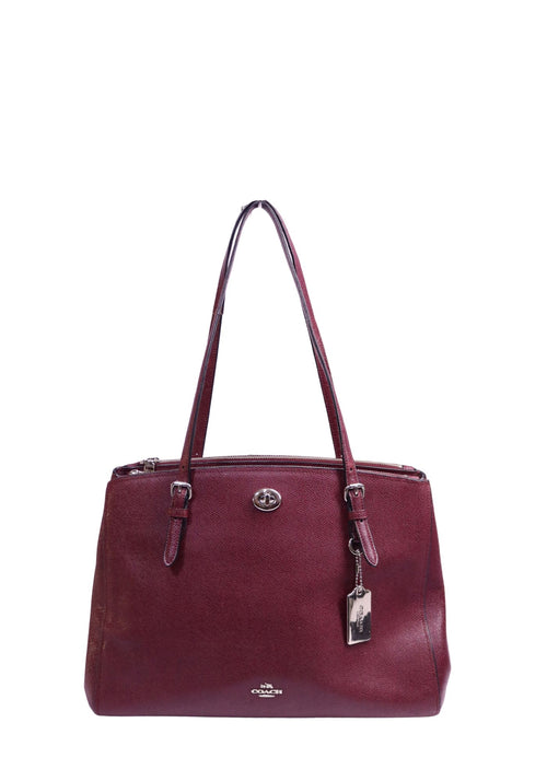 Coach burgundy crossgrain leather tote bag with silver-tone hardware, front turnlock pocket, dual handles, and detachable logo hangtag