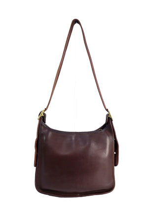 Vintage Coach shoulder bag crafted in dark brown leather featuring a minimalist rectangular silhouette, adjustable shoulder strap, brass-tone hardware