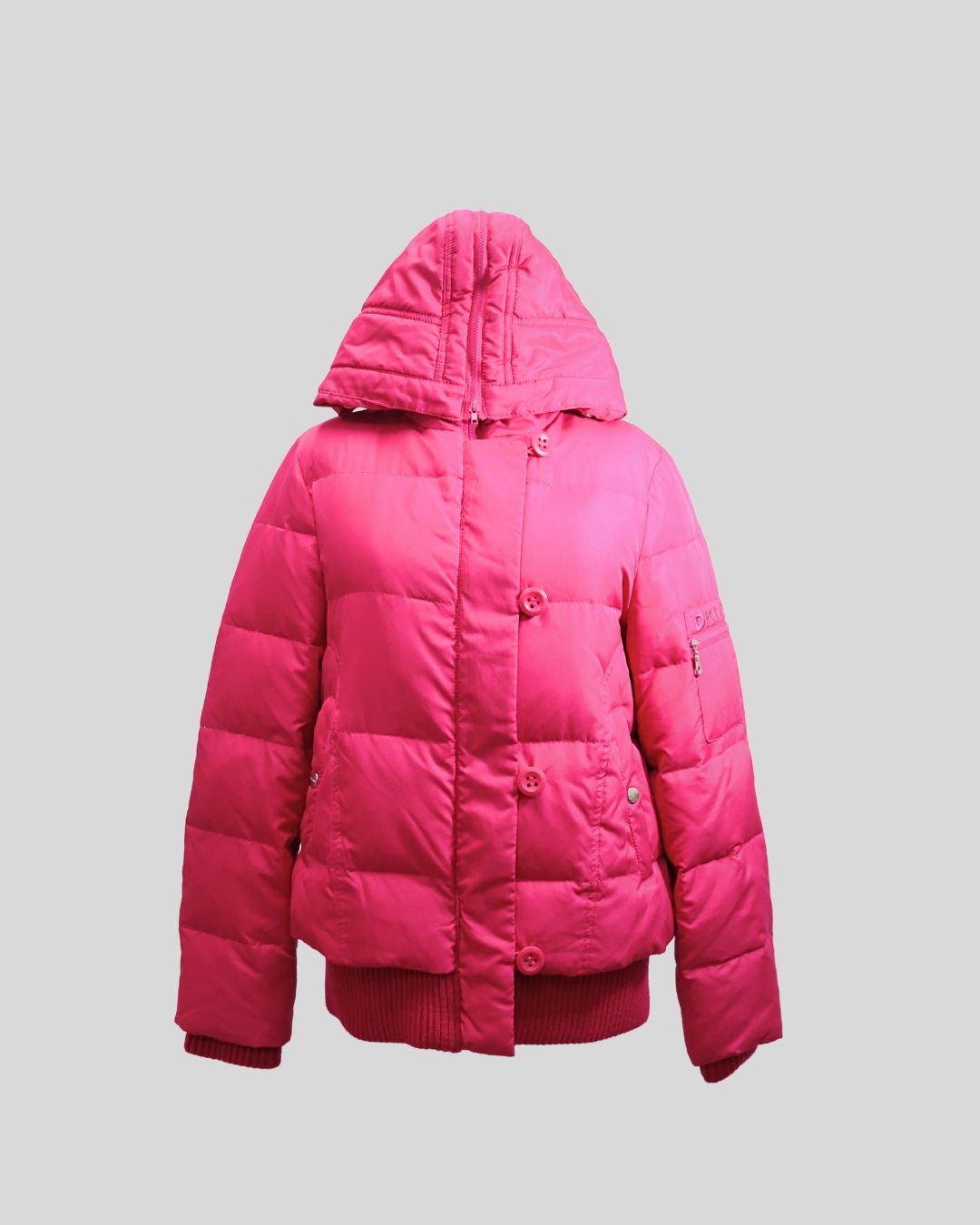 Stay warm in style with this DKNY pink hooded puffer jacket, designed to combine comfort and modern urban fashion. Crafted with quilted insulation, this jacket features a detachable hood, front button closure, and ribbed hem and cuffs to lock in warmth wh Stay warm in style with this DKNY pink hooded puffer jacket, designed to combine comfort and modern urban fashion. Crafted with quilted insulation, this jacket features a detachable hood, front button closure, and ribbed hem and cuffs to lock in warmth wh