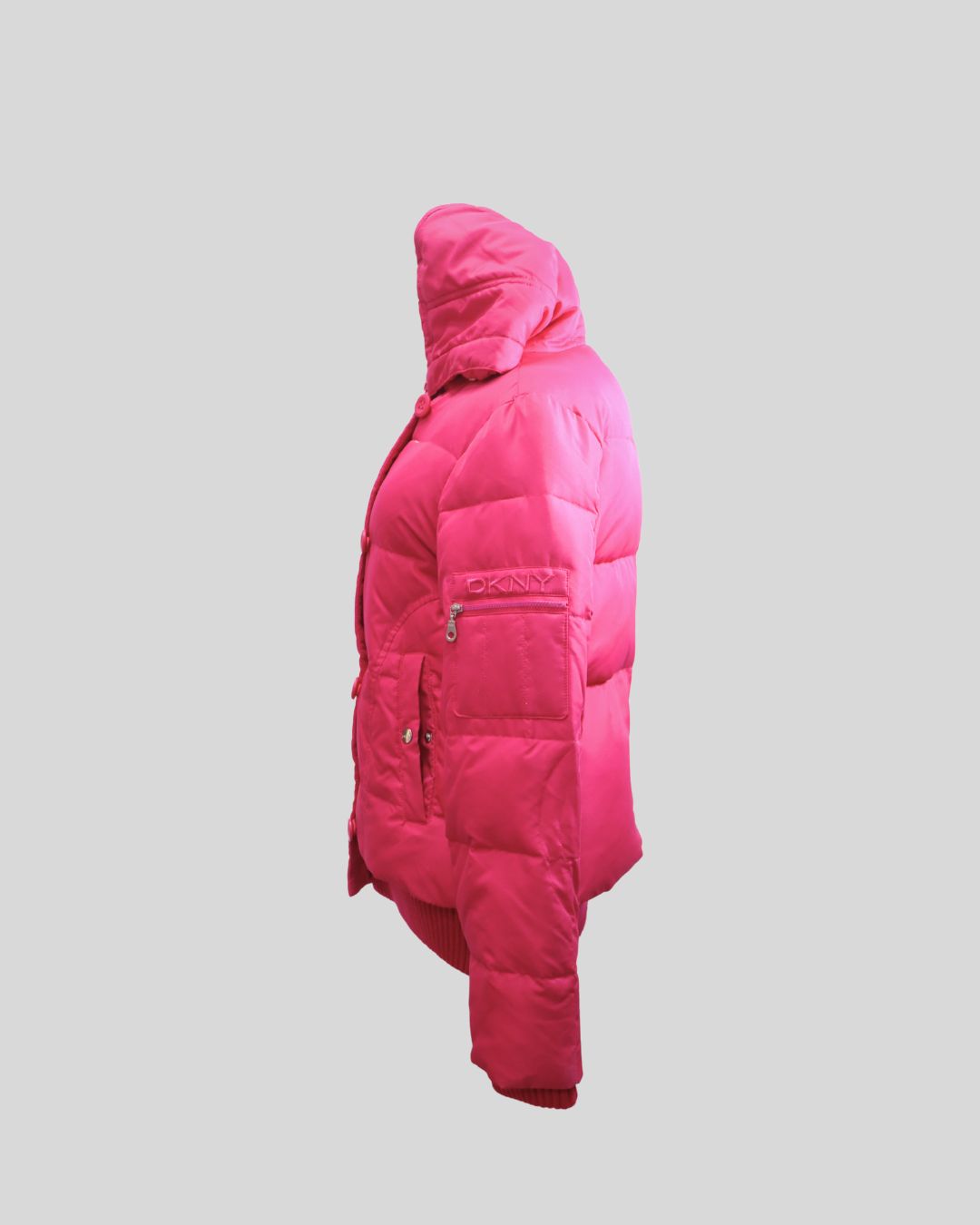 Stay warm in style with this DKNY pink hooded puffer jacket, designed to combine comfort and modern urban fashion. Crafted with quilted insulation, this jacket features a detachable hood, front button closure, and ribbed hem and cuffs to lock in warmth wh Stay warm in style with this DKNY pink hooded puffer jacket, designed to combine comfort and modern urban fashion. Crafted with quilted insulation, this jacket features a detachable hood, front button closure, and ribbed hem and cuffs to lock in warmth wh
