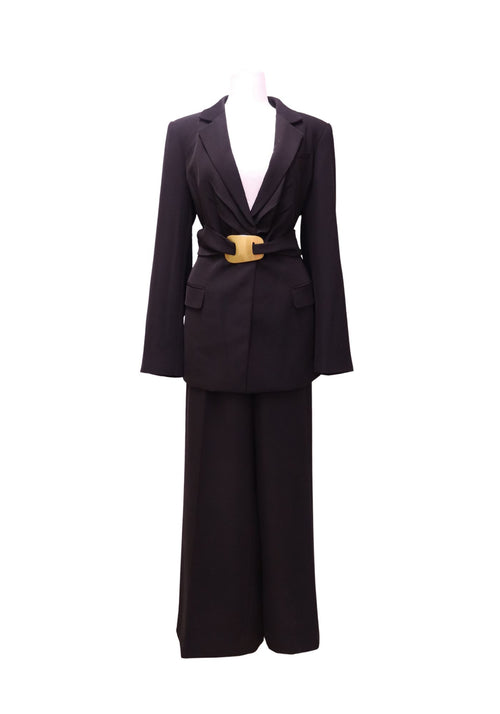 DKNY black two-piece pantsuit featuring a tailored belted blazer with a gold-tone buckle detail and matching wide-leg trousers in a sophisticated monochrome design