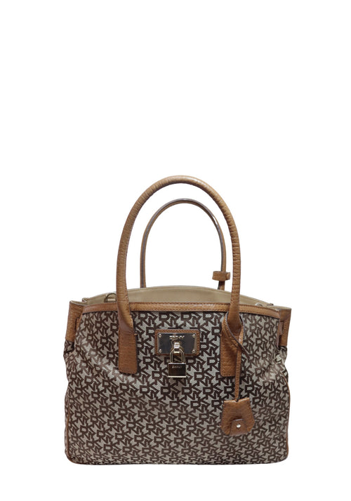DKNY brown monogram canvas tote bag with pebbled leather trim, dual top handles, removable shoulder strap, and gold-tone hardware.