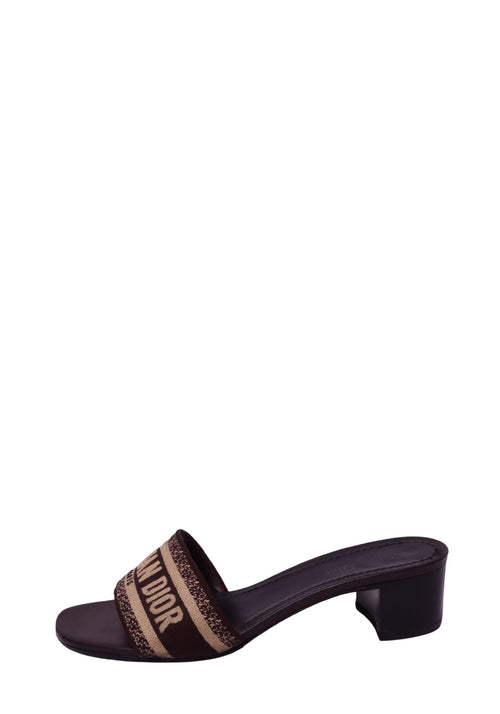Christian Dior brown and beige heeled slide sandal featuring a wide woven Christian Dior logo strap, open toe, dark brown footbed, and mid-height block heel