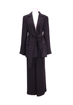 DKNY black pinstripe two-piece suit set featuring a tailored belted blazer with notched lapels and matching wide-leg trousers