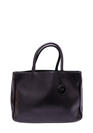 Furla black leather tote bag with dual rolled handles, coordinating leather charm, and minimalist design.