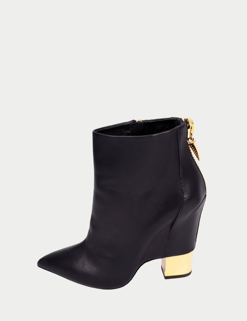 Giuseppe Zanotti black leather ankle boots with pointed toe, gold metallic block heel, and side zip closure